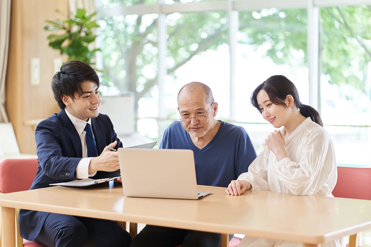Group discussing at a table with laptop