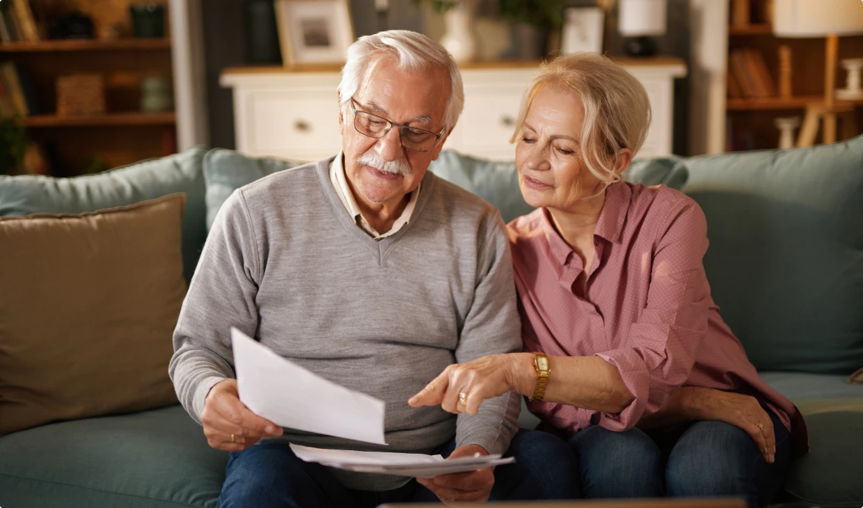 Elderly couple reviewing documents at home