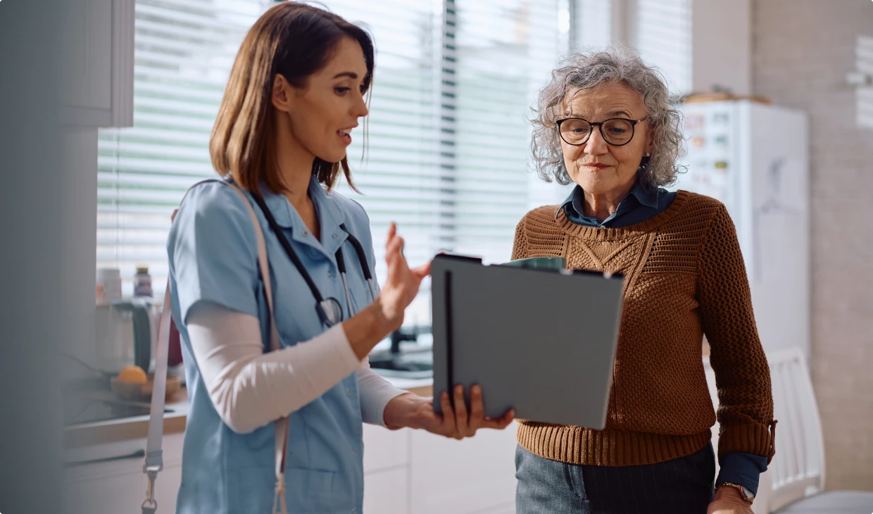 Healthcare professional consulting with elderly patient