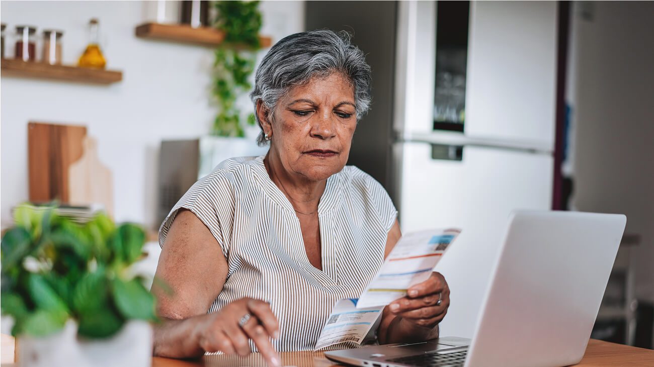 Woman reviewing documents at kitchen table
