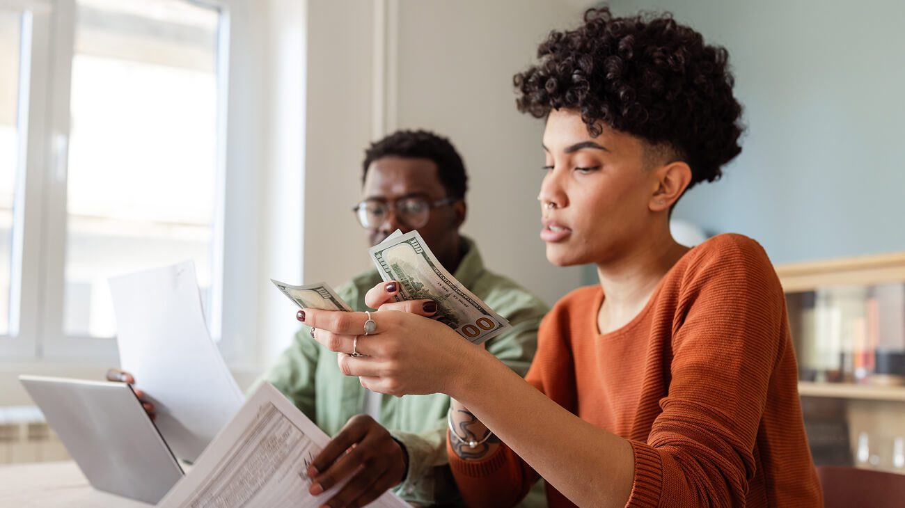 Couple managing finances together at home.
