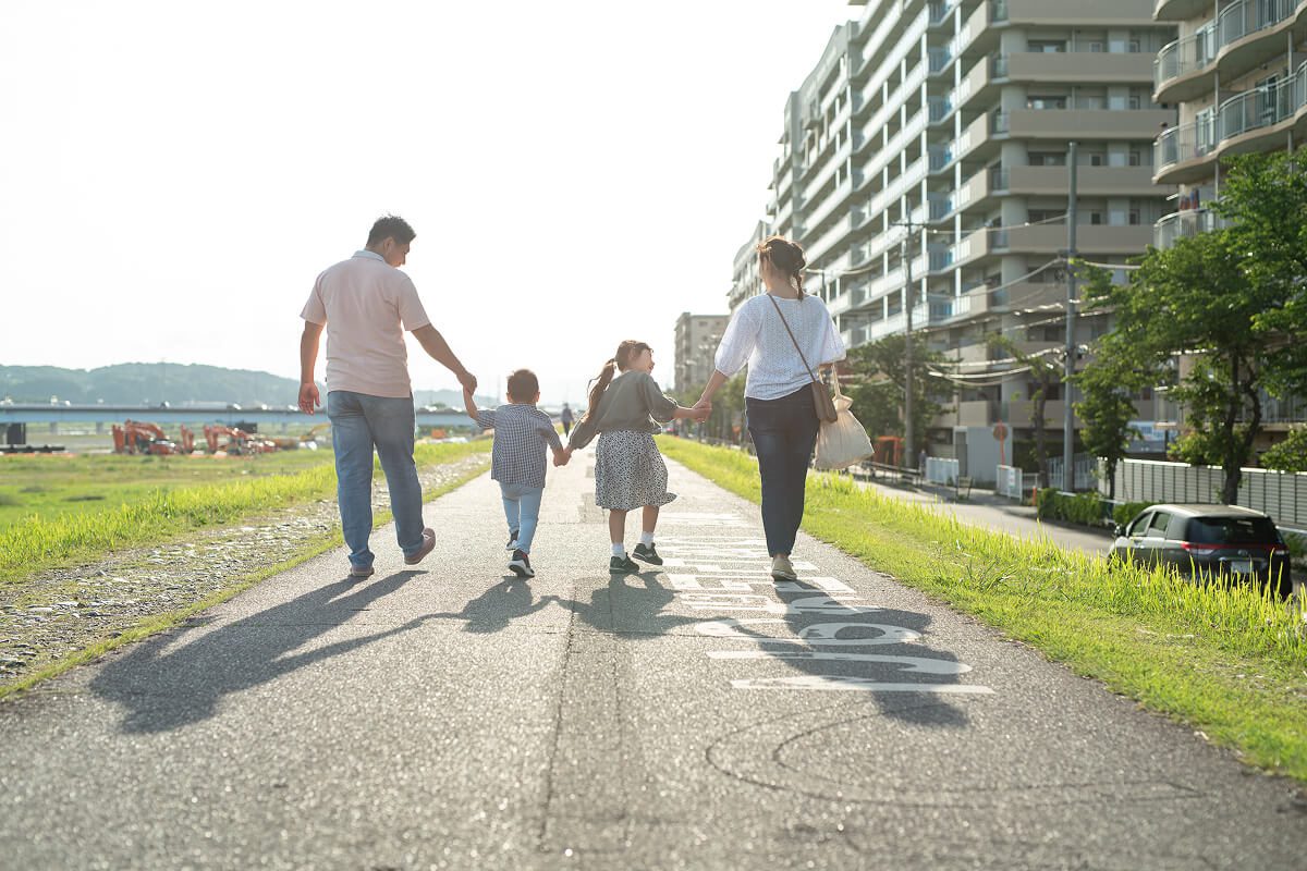 Family walking down sunny path