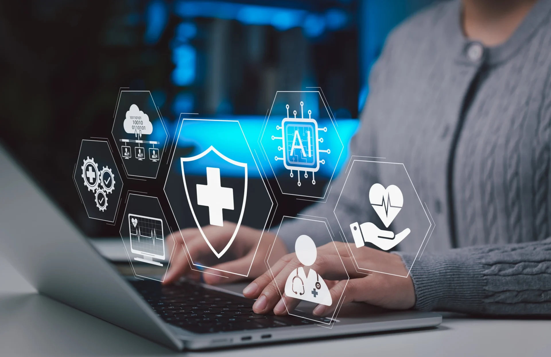 Person using laptop with healthcare digital icons.