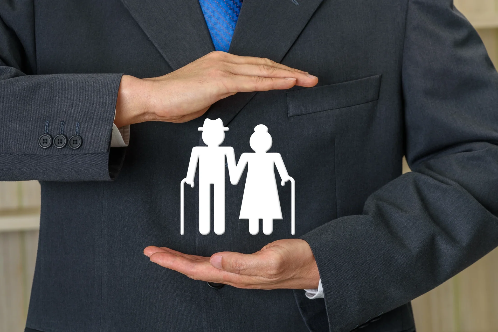 Businessman holding elderly couple icon.