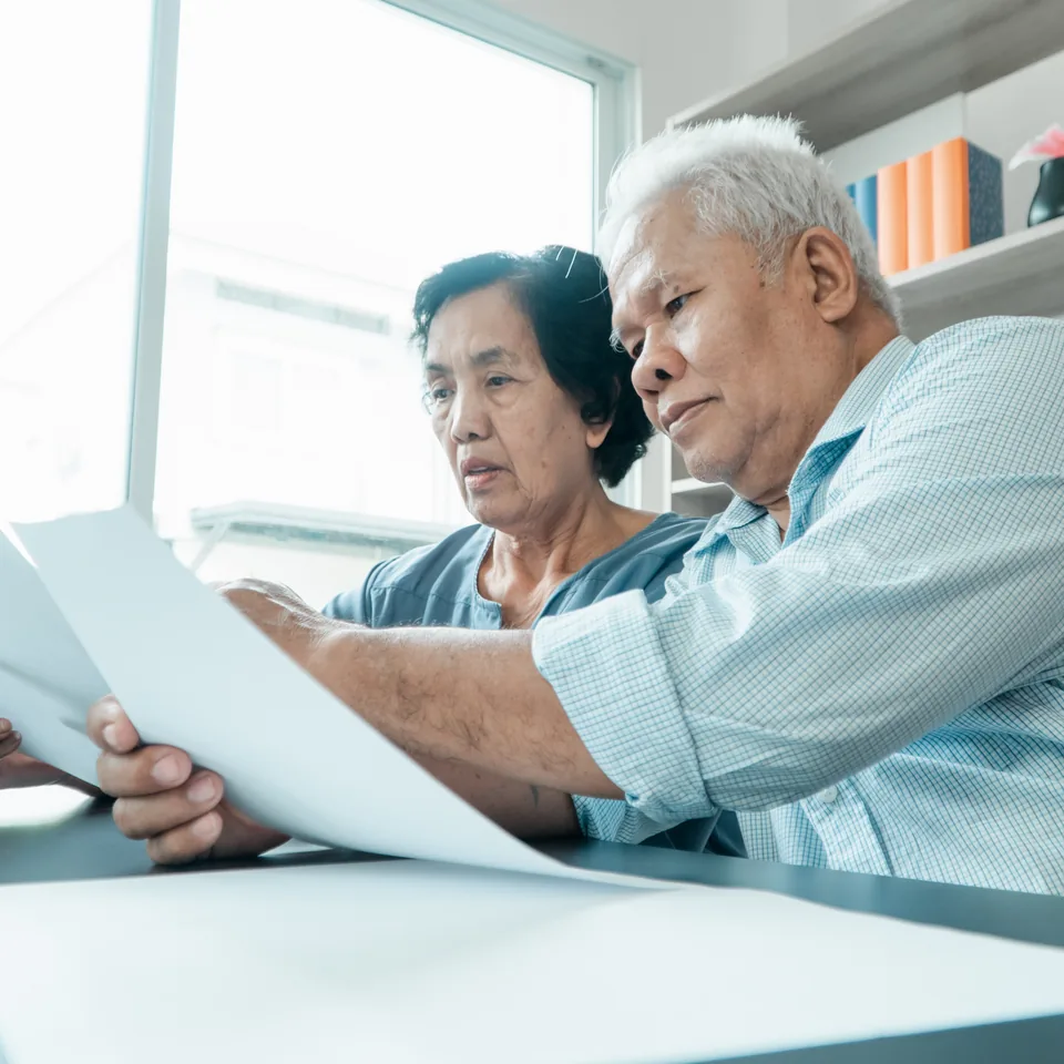 Older couple reviewing their household finances