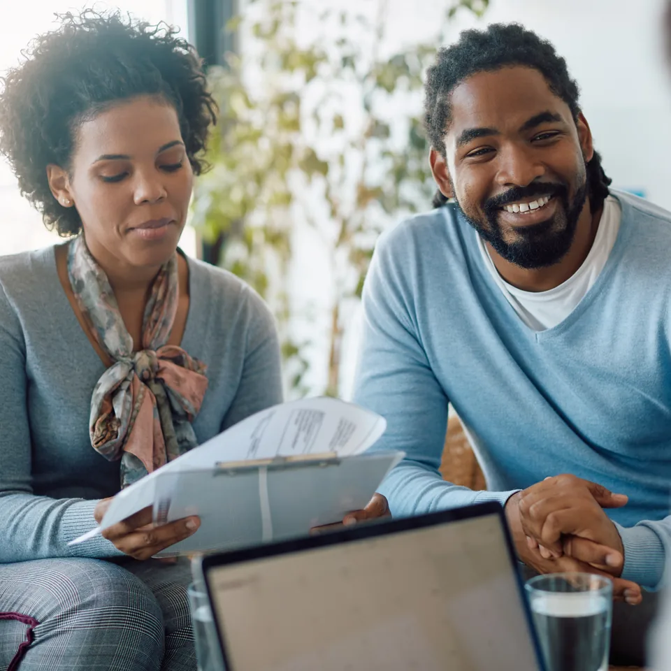 Couple reviewing paperwork with an adviser