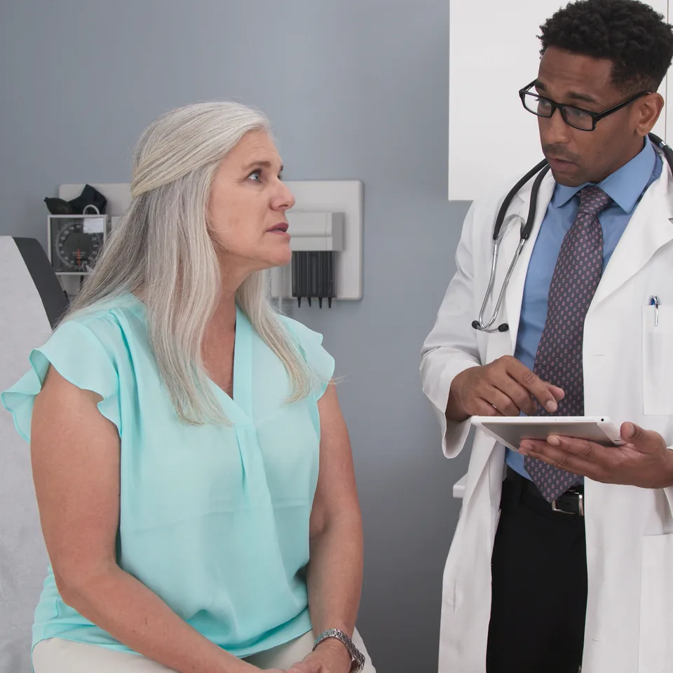 Older woman discussing care with a doctor